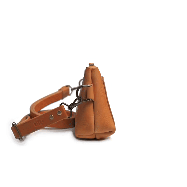 360-degree rotating view of the McKay Avalon leather crossbody belt bag showing brass zipper, front pocket, and adjustable strap