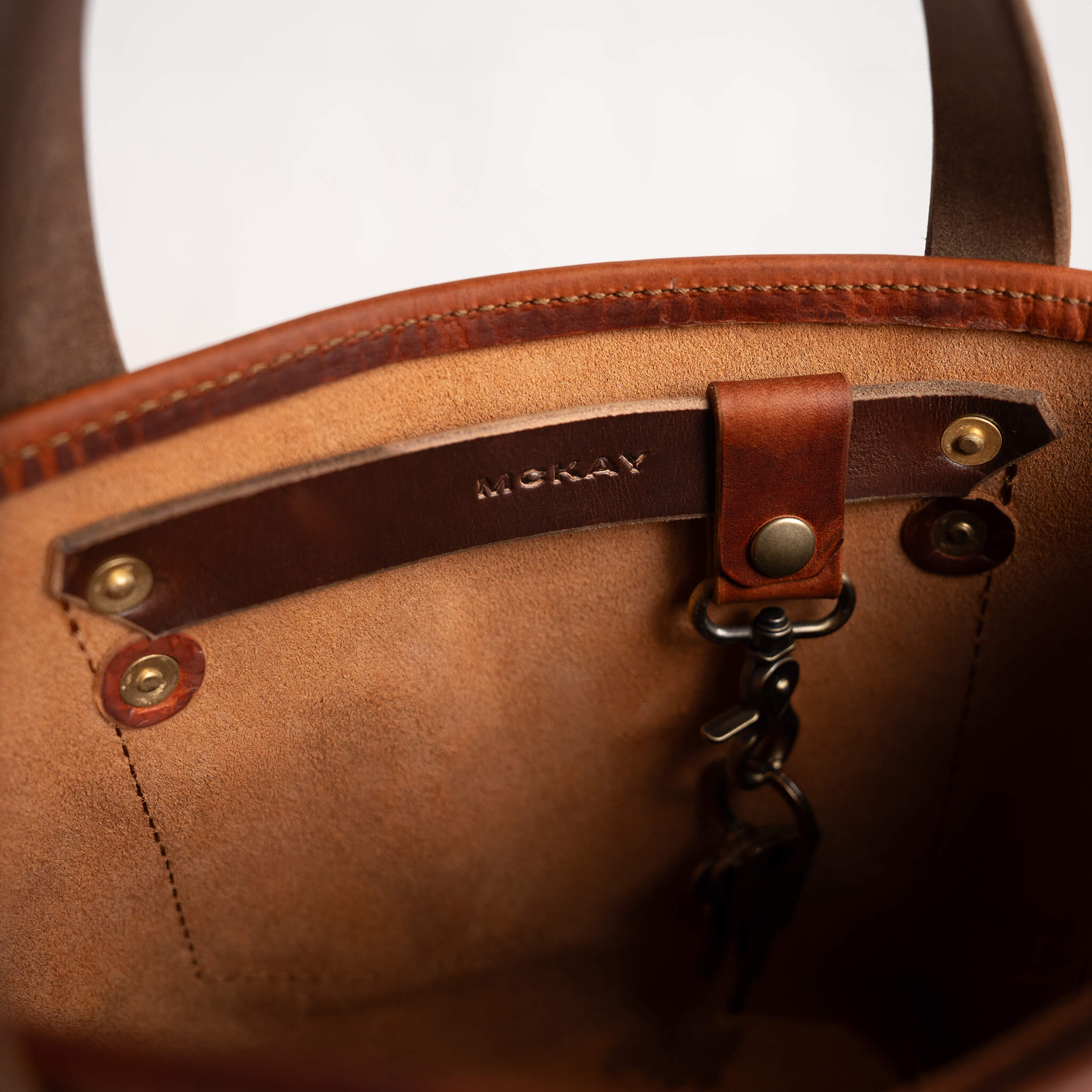 McKay branded interior mini tote swivel key clip attachment full grain veg tan leather detail