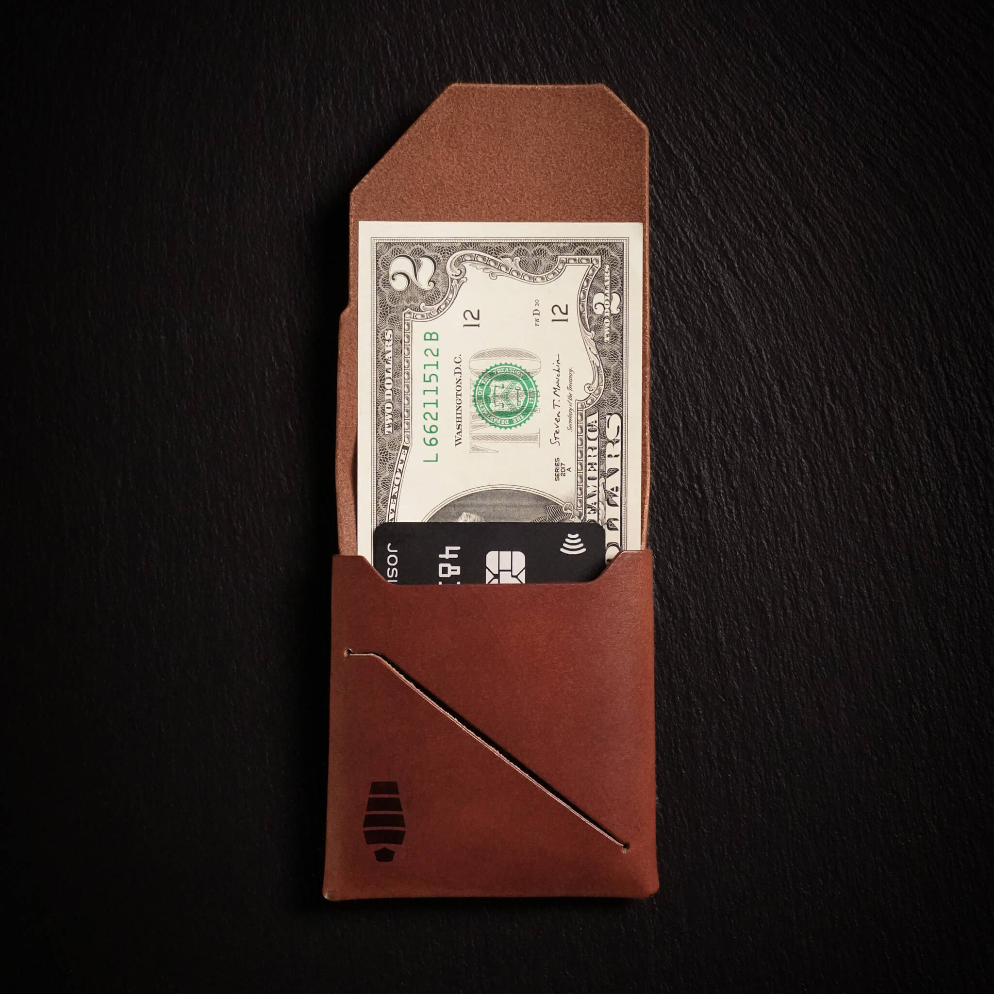 Voyager minimalist wallet in Havana Brown unfolded and open showing cash visible in Tuck & Go billfold pocket and its slim profile with stitchless leather construction