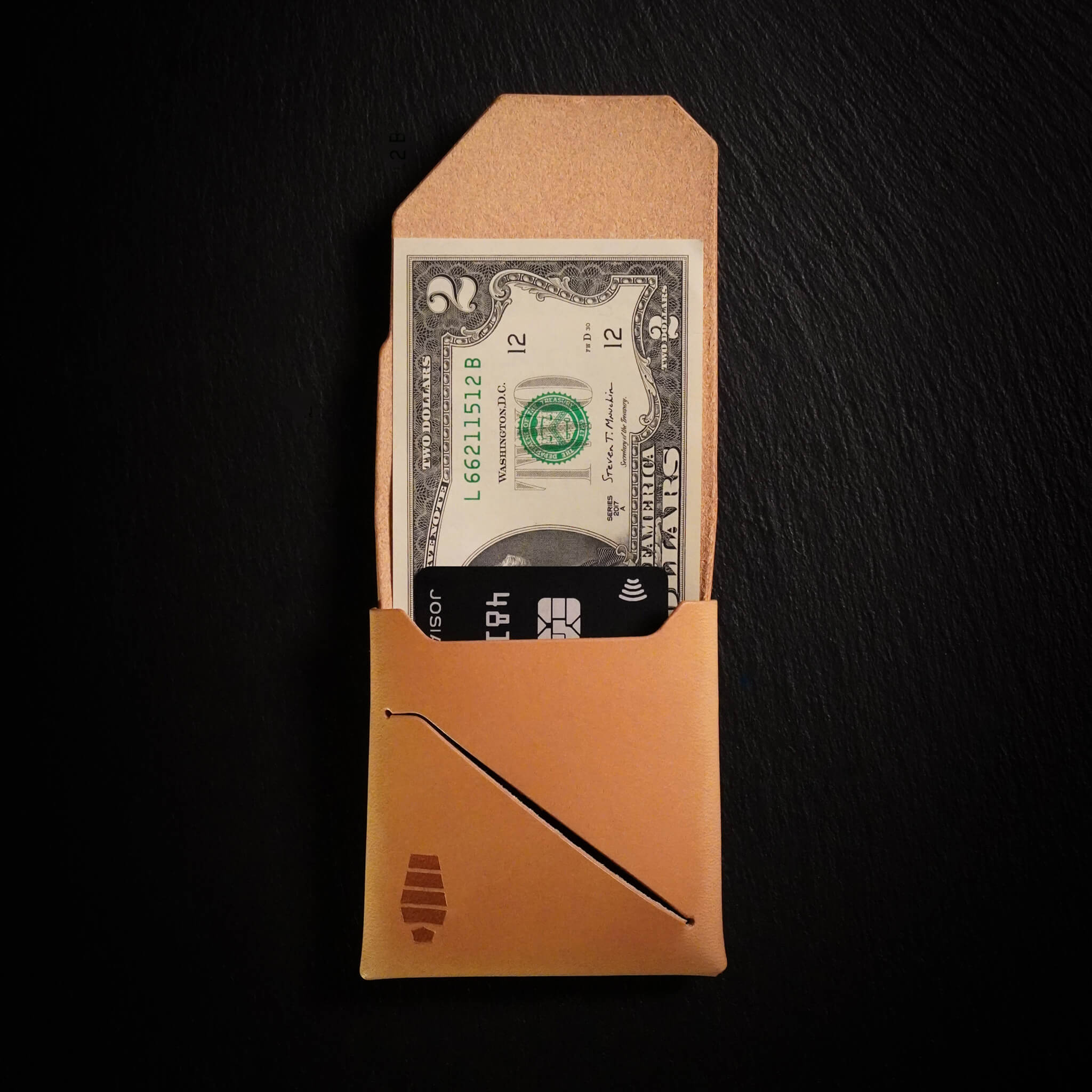 Voyager minimalist wallet in Sand Tan color unfolded and open showing cash visible in Tuck & Go billfold pocket and its slim profile with stitchless leather construction