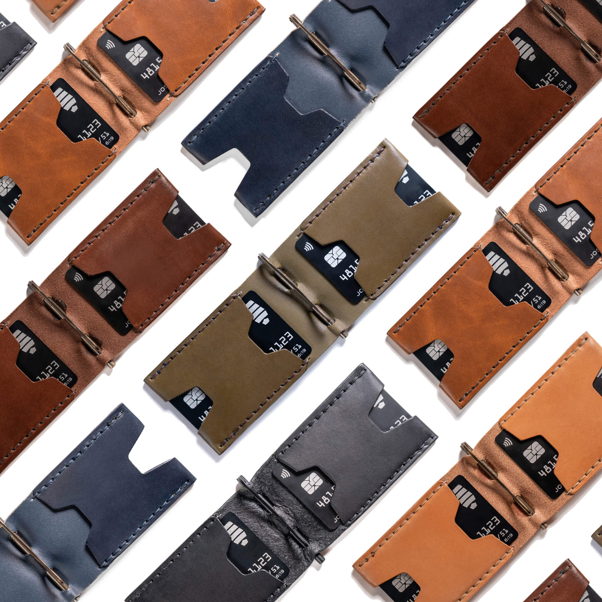 Flat lay of Windward leather wallets in multiple colors lying open with visible card slots