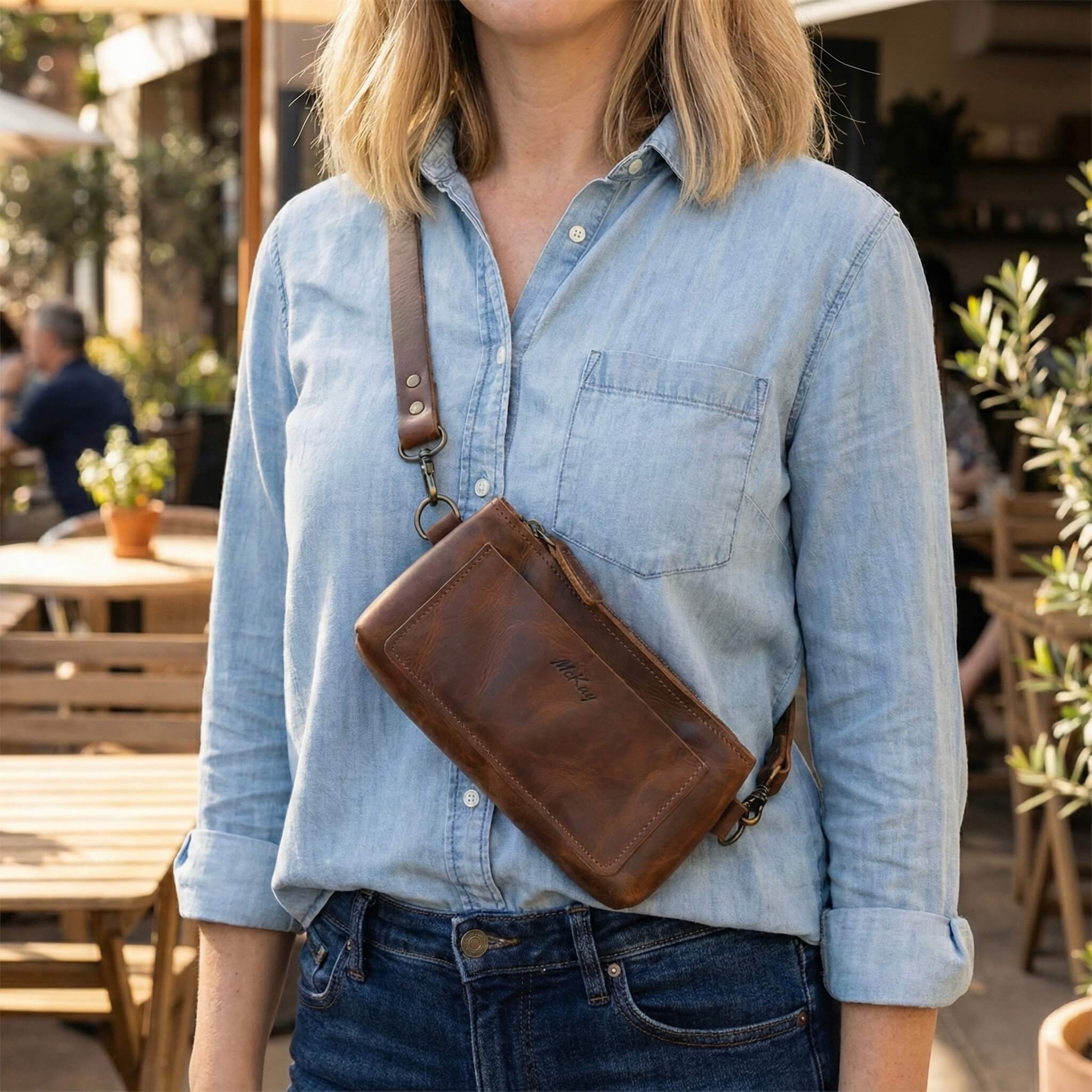 The Avalon Crossbody Bag in Sable leather worn crossbody, featuring a deep brown finish, adjustable leather strap, and cute profile—handmade in the USA for hands-free comfort, travel, and daily essentials with timeless style.