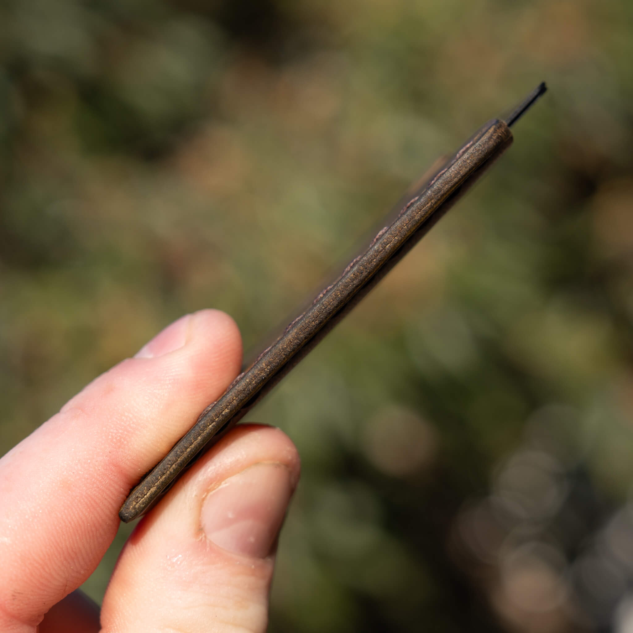 Ultra-slim profile view of the Ulysses leather card sleeve showing minimal thickness.